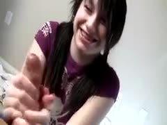 A gorgeous amateur brunette of legal age, sporting brackets, is toying with a dick.